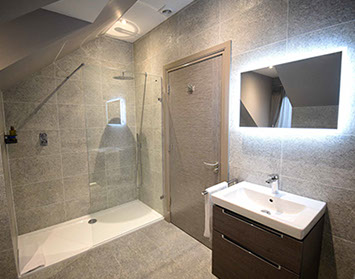 Taransay House Luxury Bed and Breakfast in Portree contains a spacious modern bathroom with bath shower and electric mirror icon
