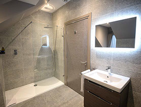 Taransay House Luxury Bed and Breakfast in Portree contains a spacious modern bathroom with bath shower and electric mirror icon